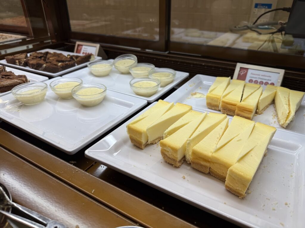 Cheesecake slices and dessert pots on buffet