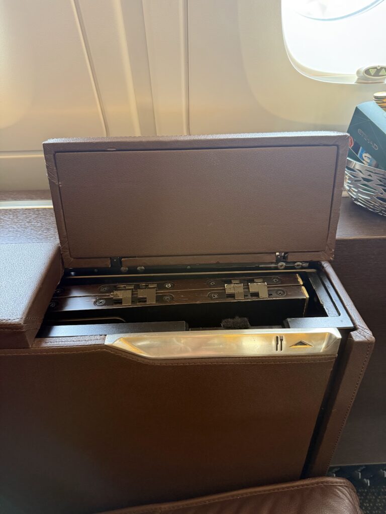 Open storage compartment beside Etihad Apartment seat