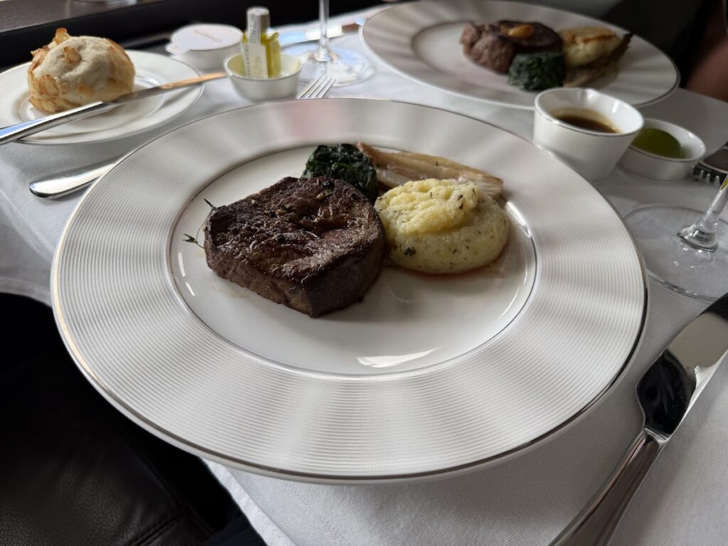 Grilled steak with polenta and spinach served in First