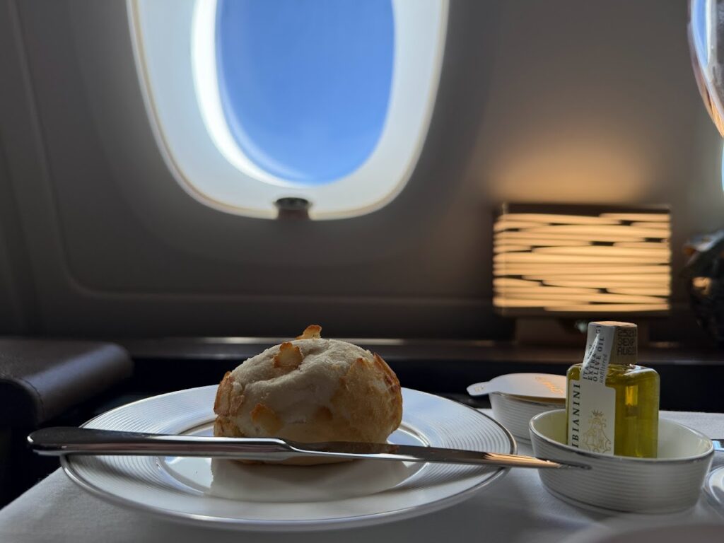 Warm bread roll and olive oil by A380 window