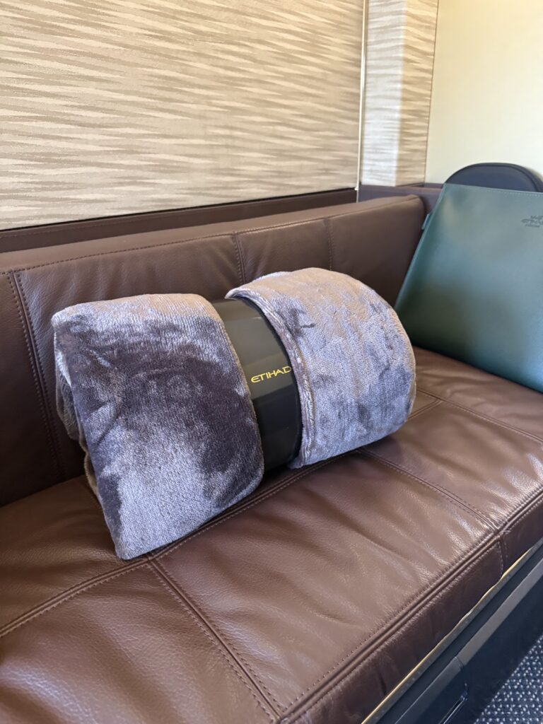 Etihad A380 Apartments blanket on leather ottoman seat
