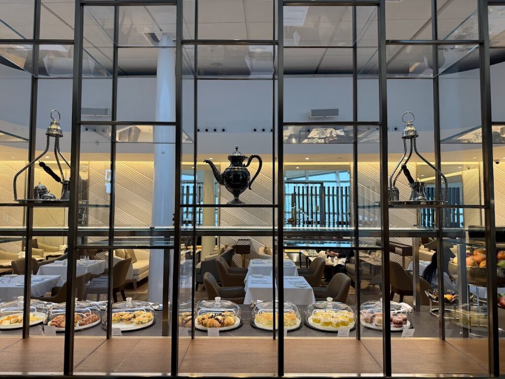 Etihad first class lounge dining area with pastries display