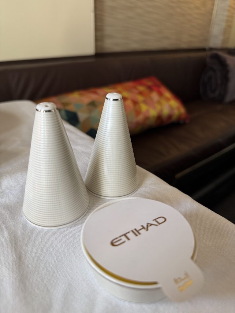 Etihad branded salt and pepper shakers on dining table