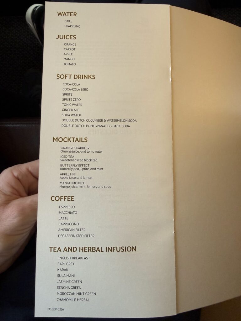 Etihad First class beverage menu held in hand