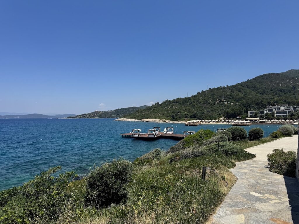 Torba beachfront with boats and hillside resort setting