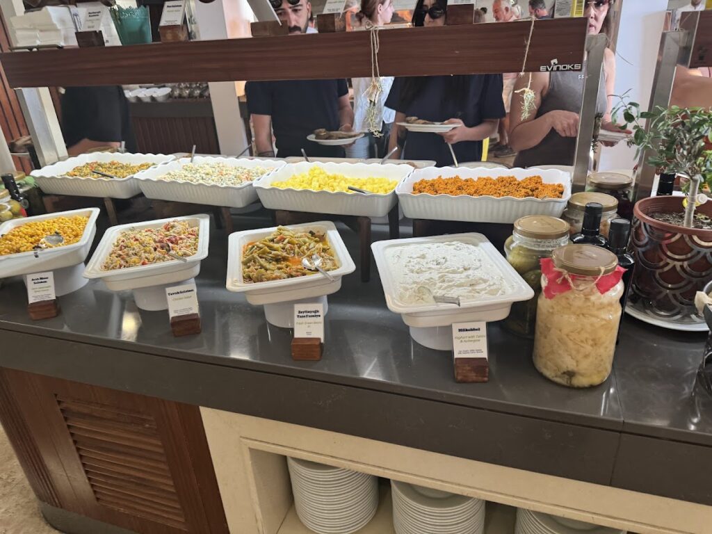 Buffet dining spread with multiple pasta and prepared dishes