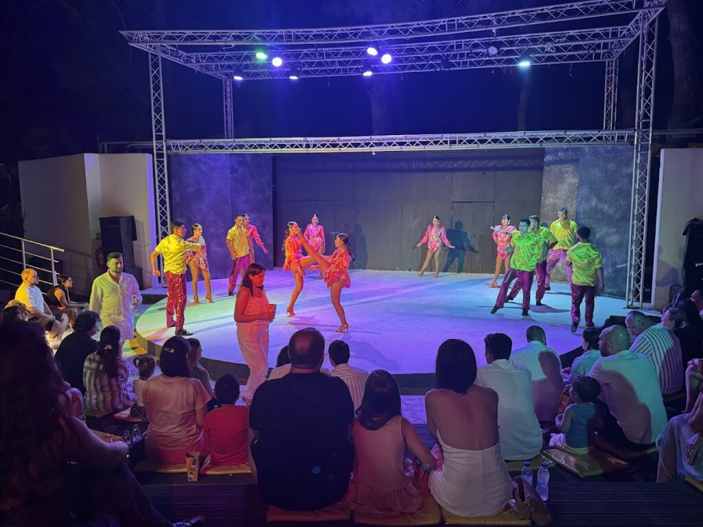 Evening entertainment show with colorful stage lighting performers