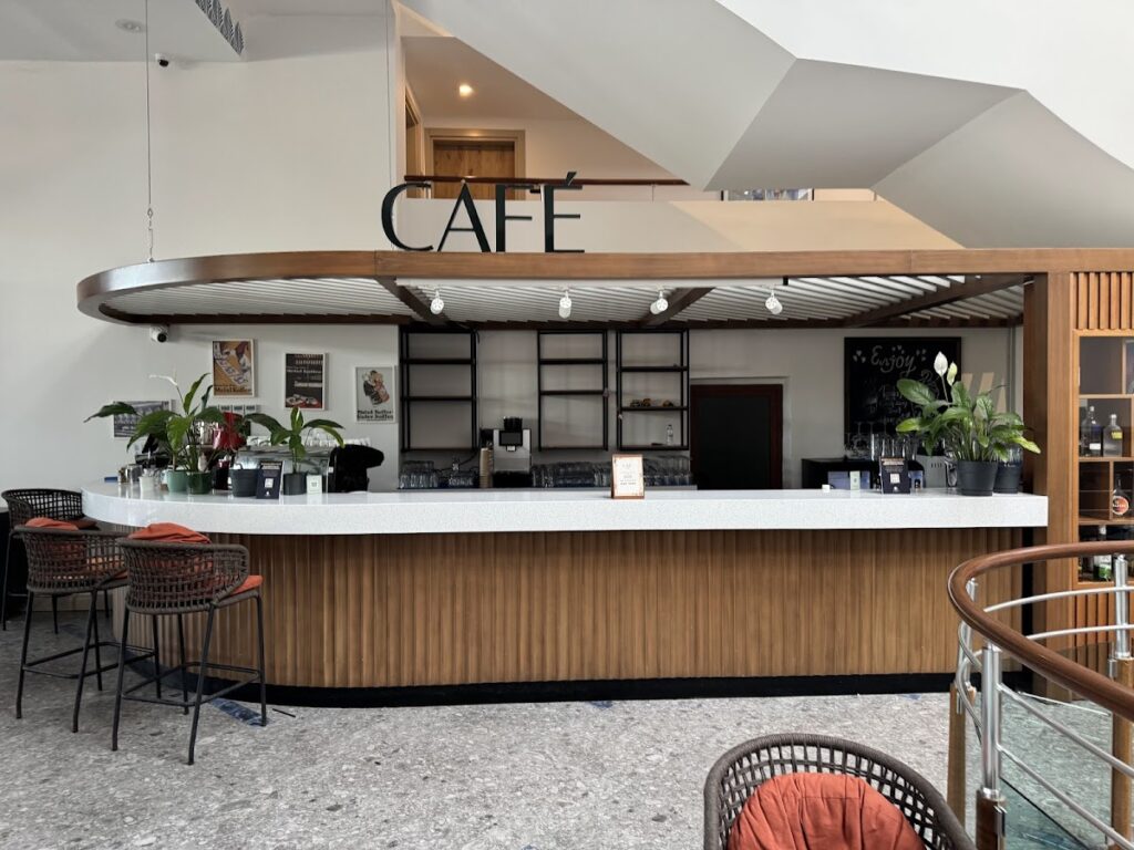 Modern café counter with white surfaces and wood accents