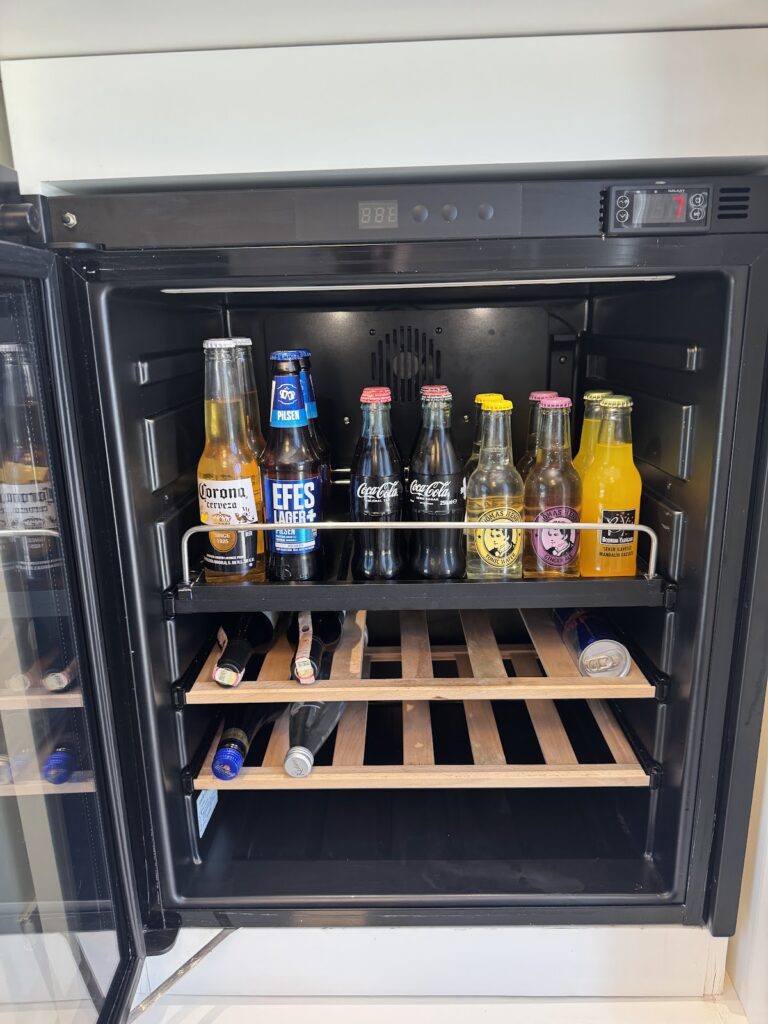 In-room beverage cooler stocked with drinks