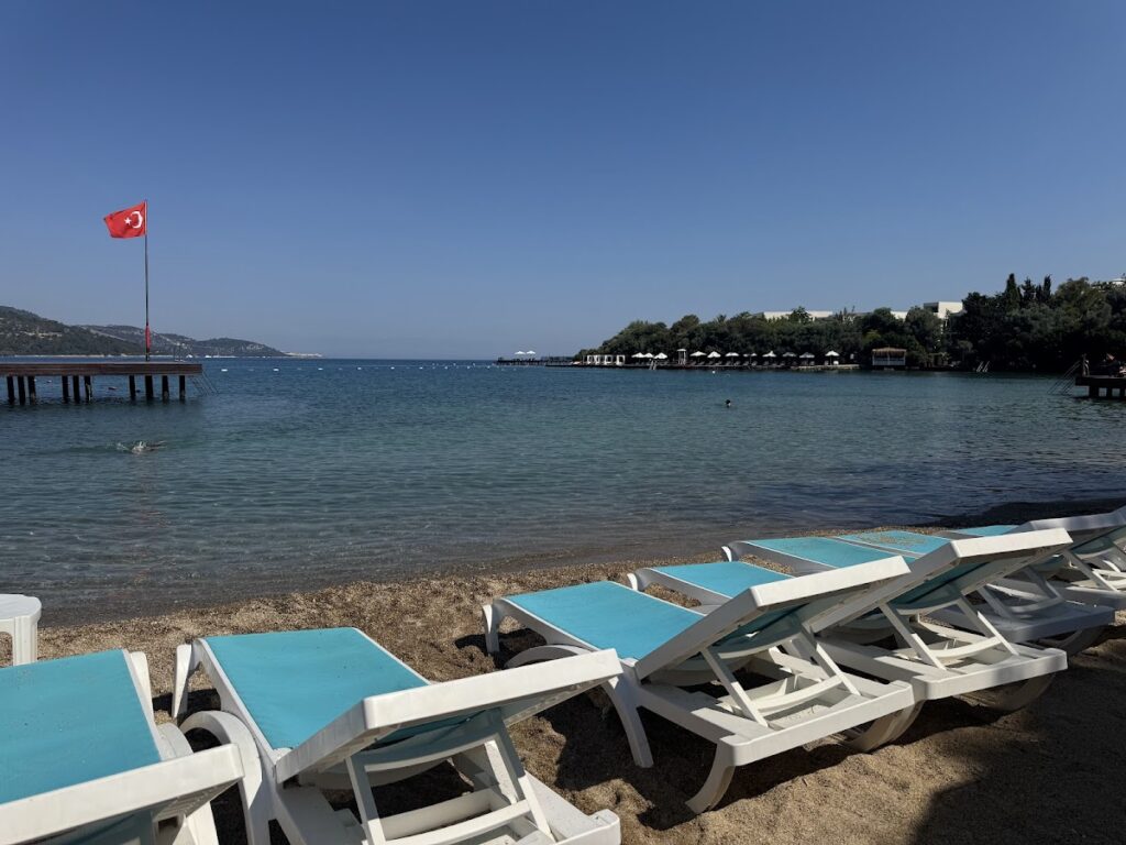 DoubleTree Bodrum beach with loungers and Turkish flag