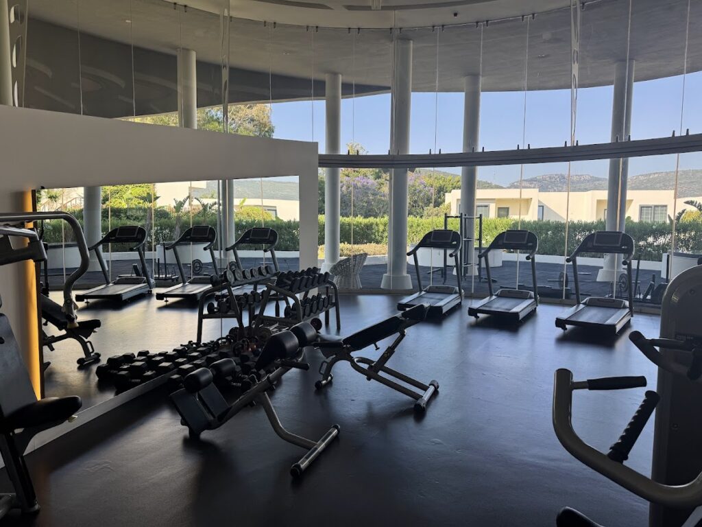 Modern fitness center with panoramic windows overlooking Bodrum landscape