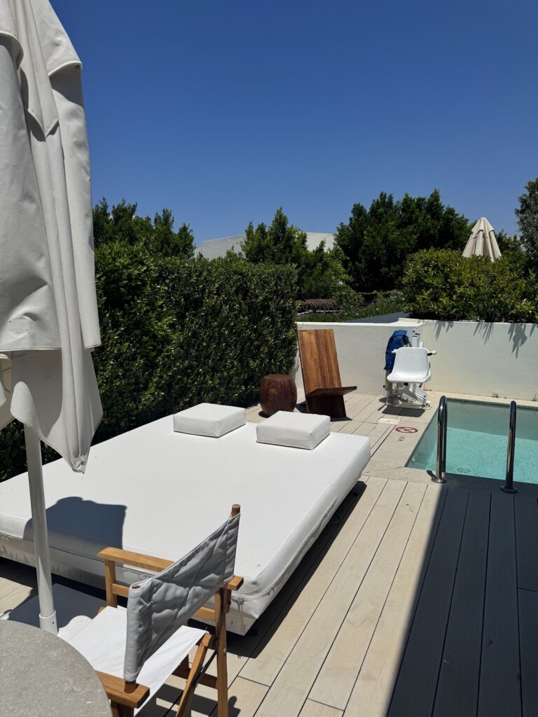 Private pool terrace with sunbed and umbrella