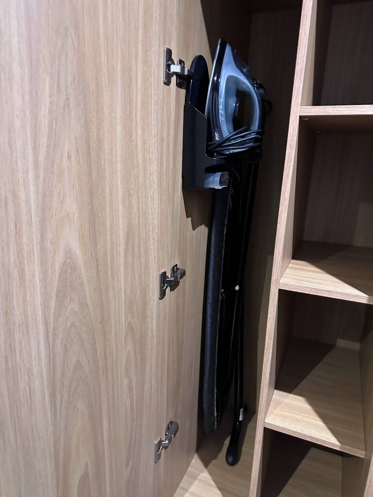 Hotel room wardrobe with ironing board stored inside