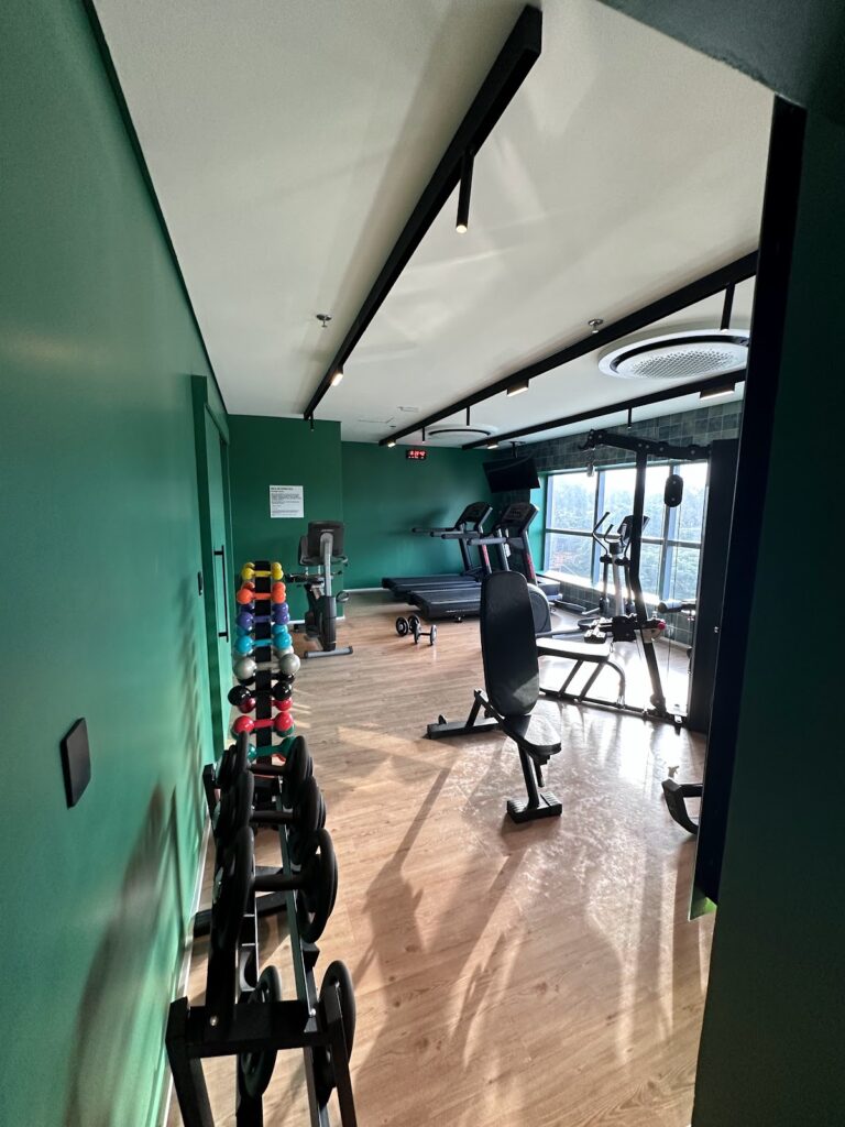 Fitness center with dumbbells, exercise bikes, treadmill