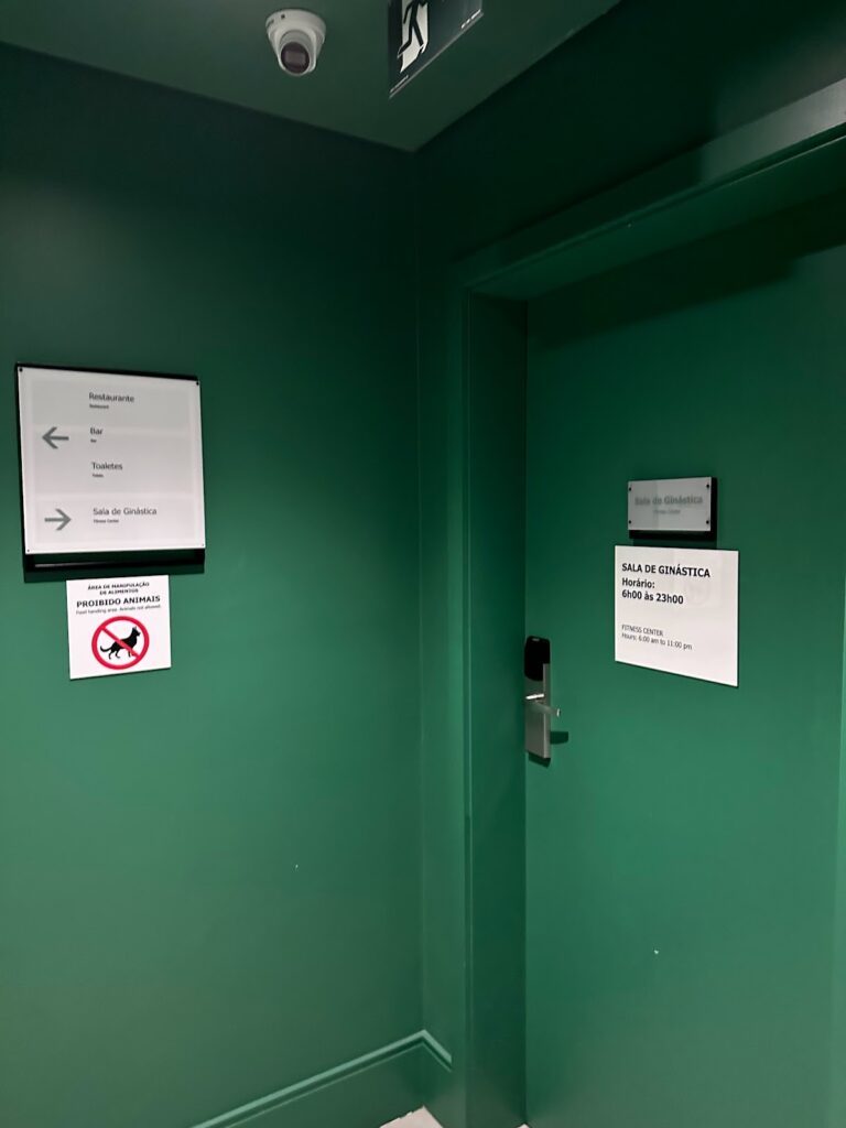 Green corridor with fitness center signage and entrance