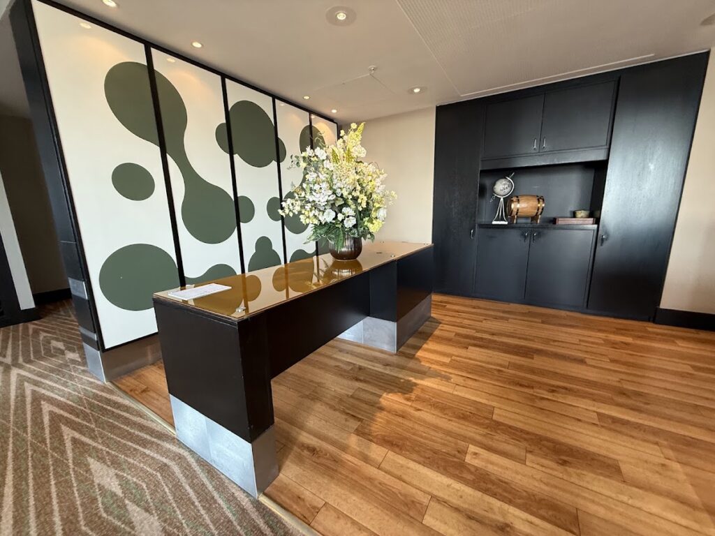 Hotel lobby with modern black desk and botanical artwork