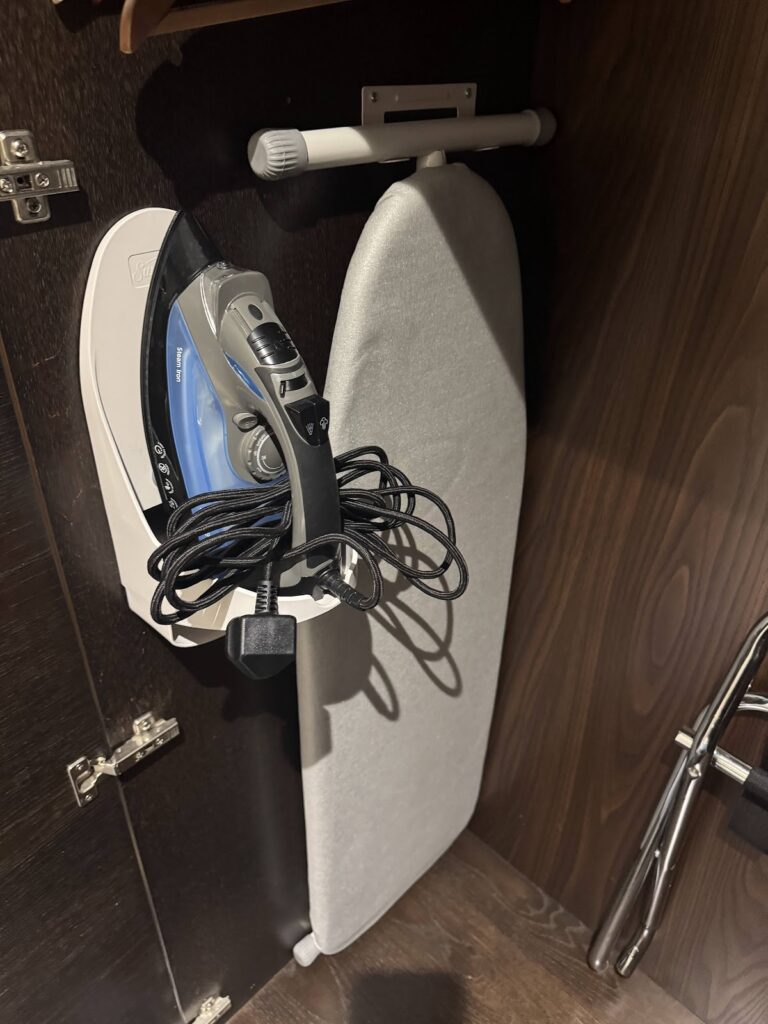 Hotel bathroom ironing board and iron storage