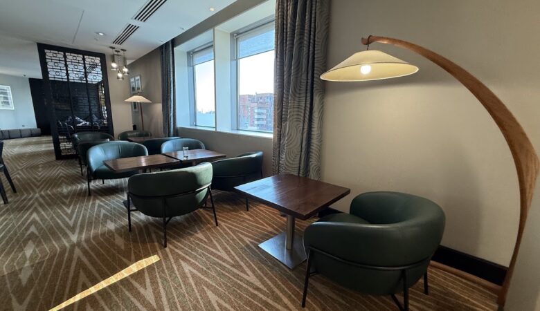 Modern executive lounge with seating and skyline views