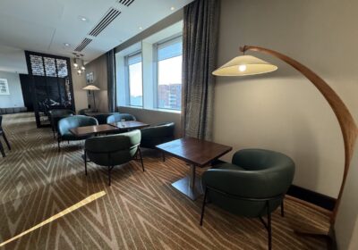 Modern executive lounge with seating and skyline views