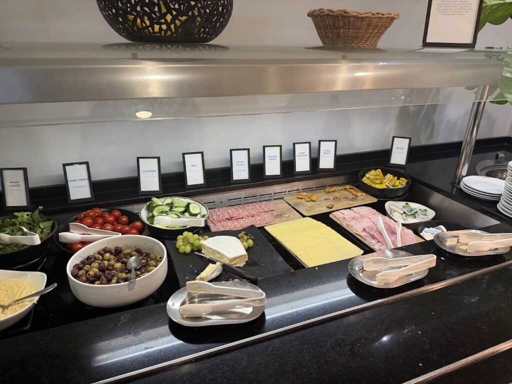 Hotel breakfast buffet cold cuts meats vegetables olives cheese