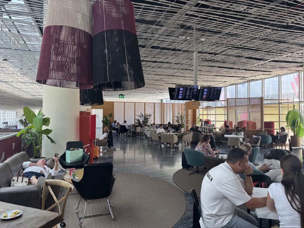 Prime Class Lounge dining area with departure boards