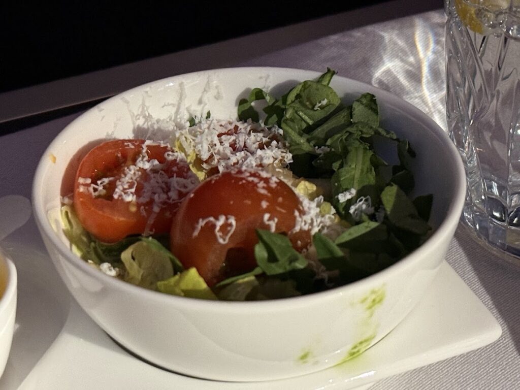 Club Suite salad course with tomato and feta cheese
