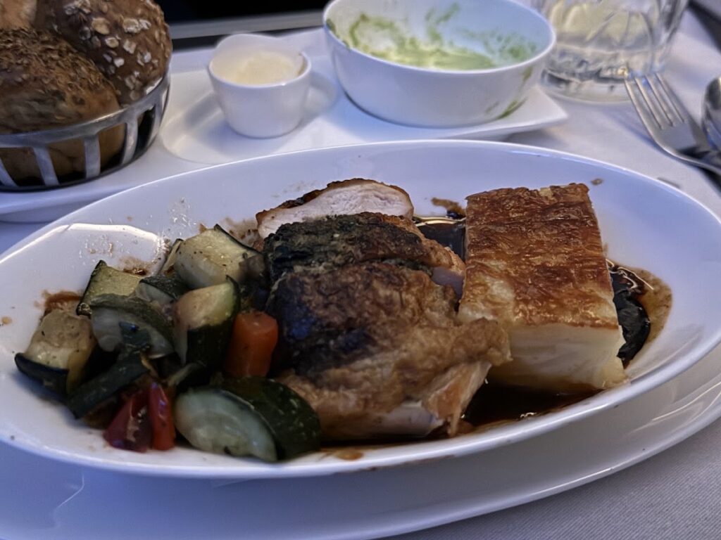 Plated beef short rib with roasted vegetables and salad