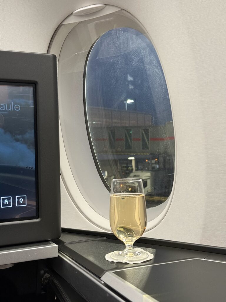 Champagne glass by Club Suite window with night view