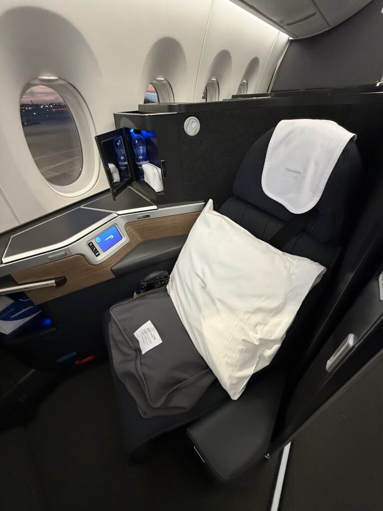 Club Suite seat with pillows and bedding setup