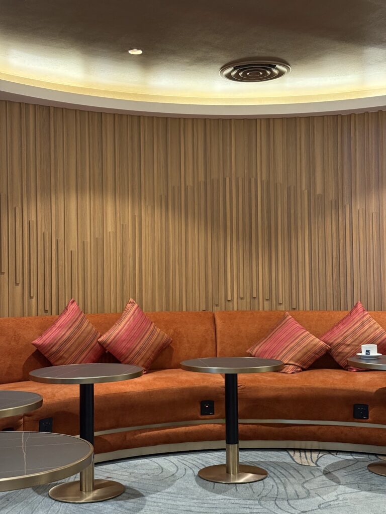 Modern lounge seating with orange sofa and striped cushions