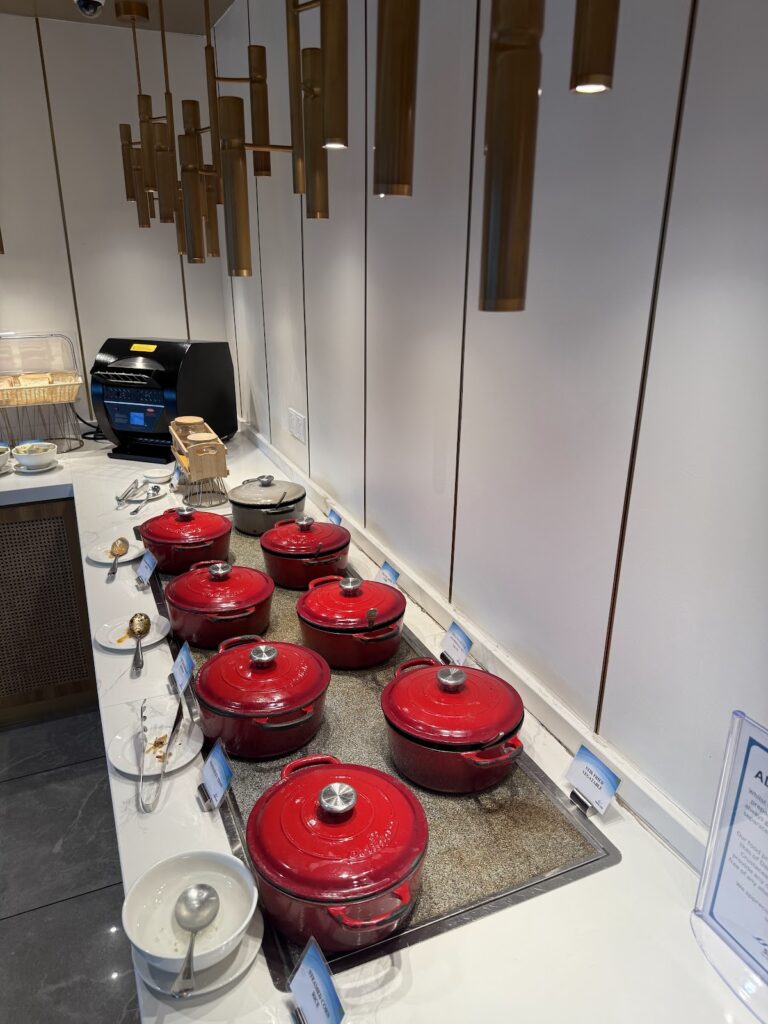 Red cookware display in airline lounge kitchen area