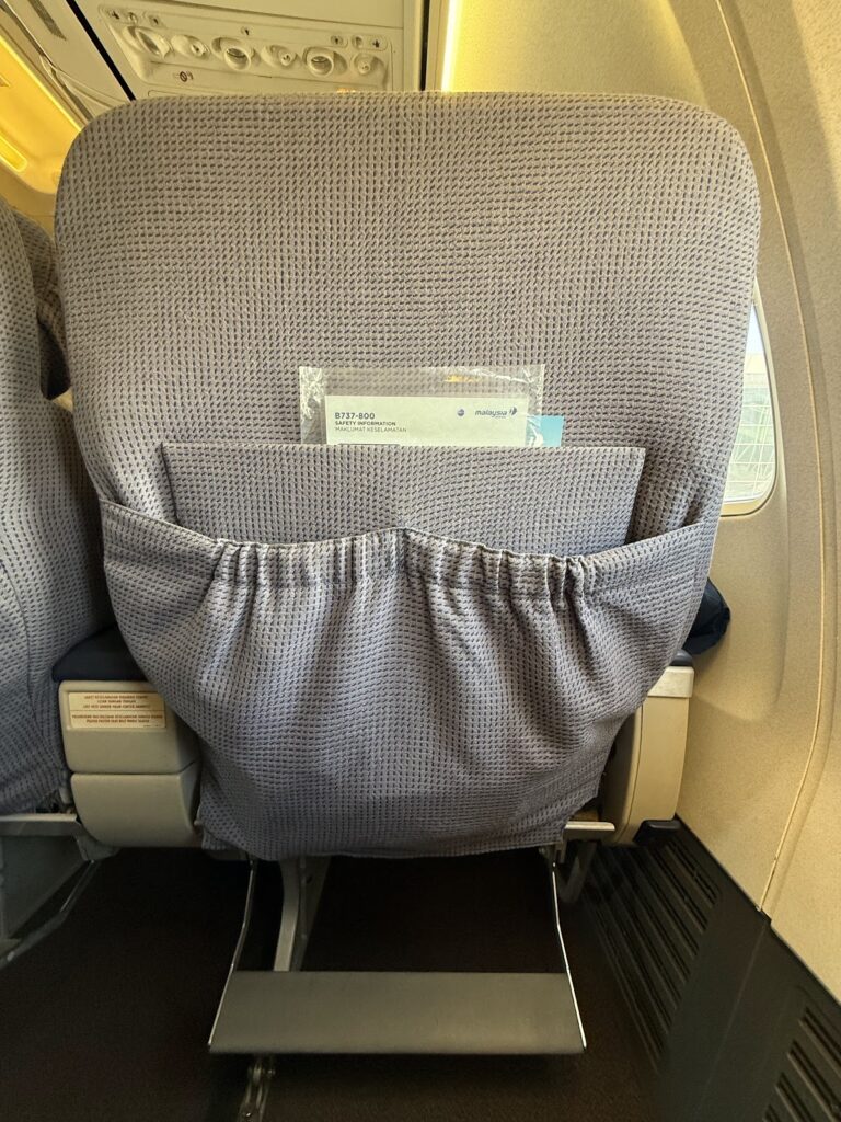 Business class seat headrest with Malaysia Airlines branding