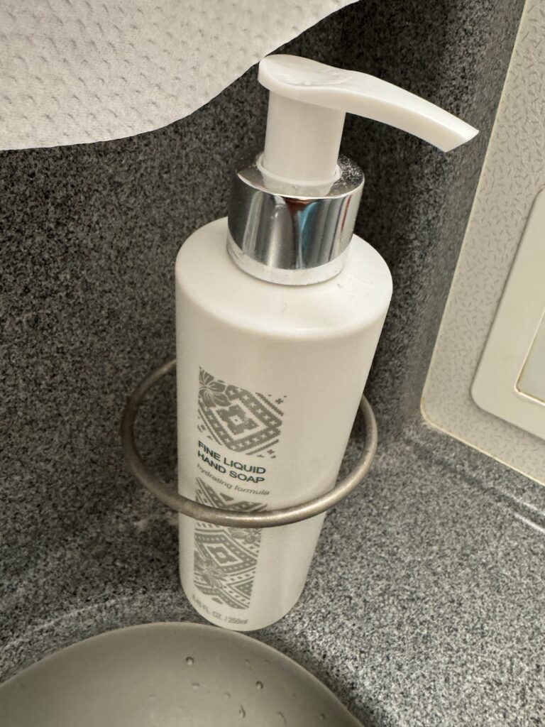 Hand soap dispenser in aircraft lavatory