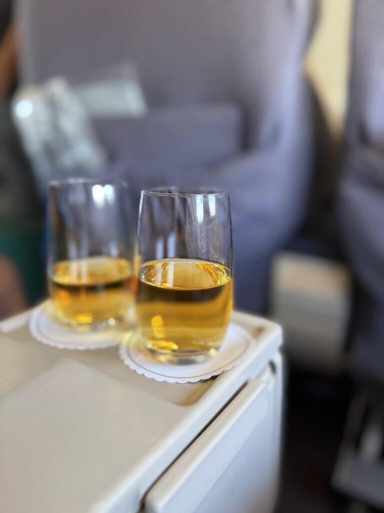 Glasses of apple juice served on business class tray