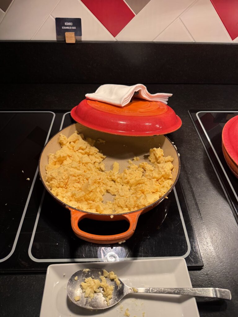 Breakfast scrambled eggs in orange Ronnecol serving dish