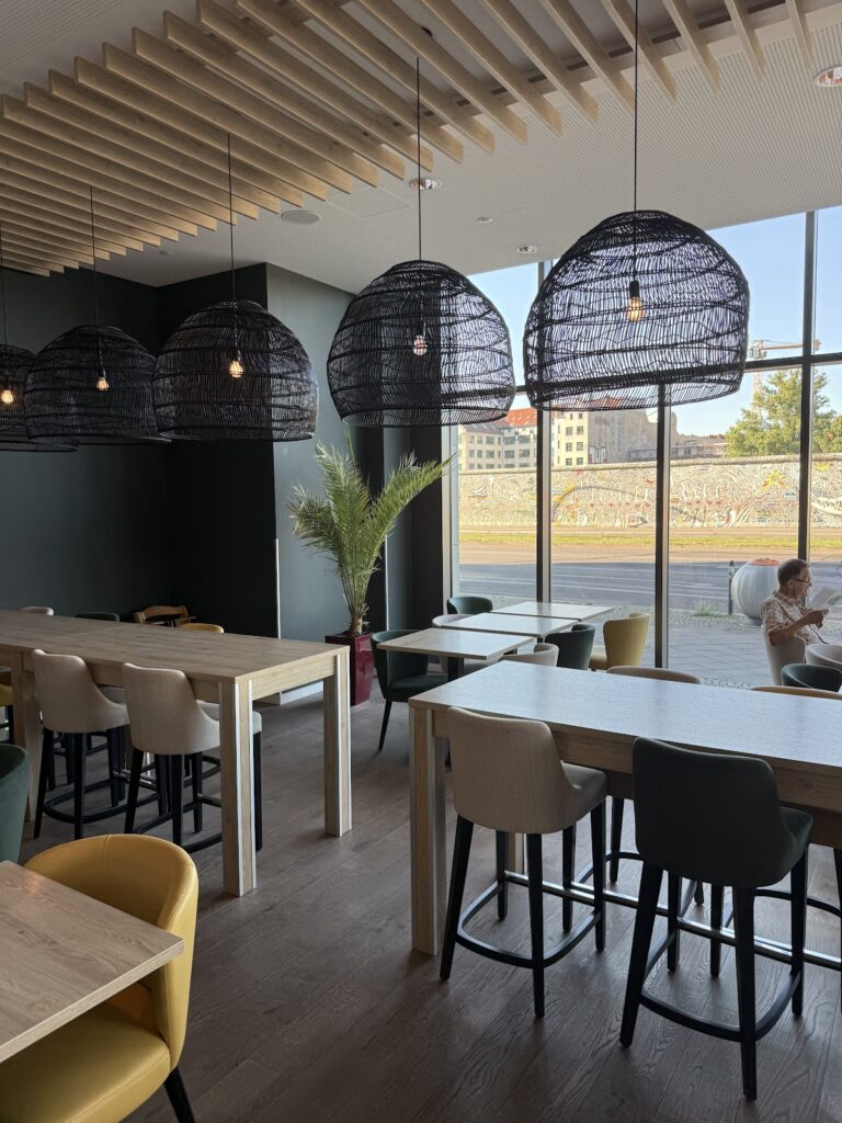 Modern lobby bar with black woven pendant lights and Berlin