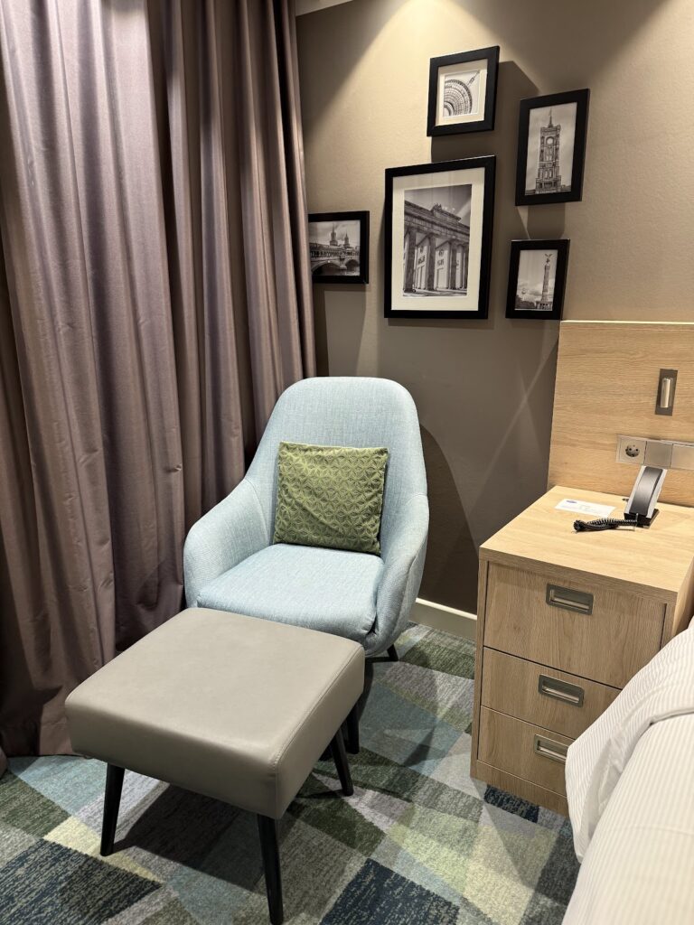 Hotel room seating area with Berlin-themed wall art