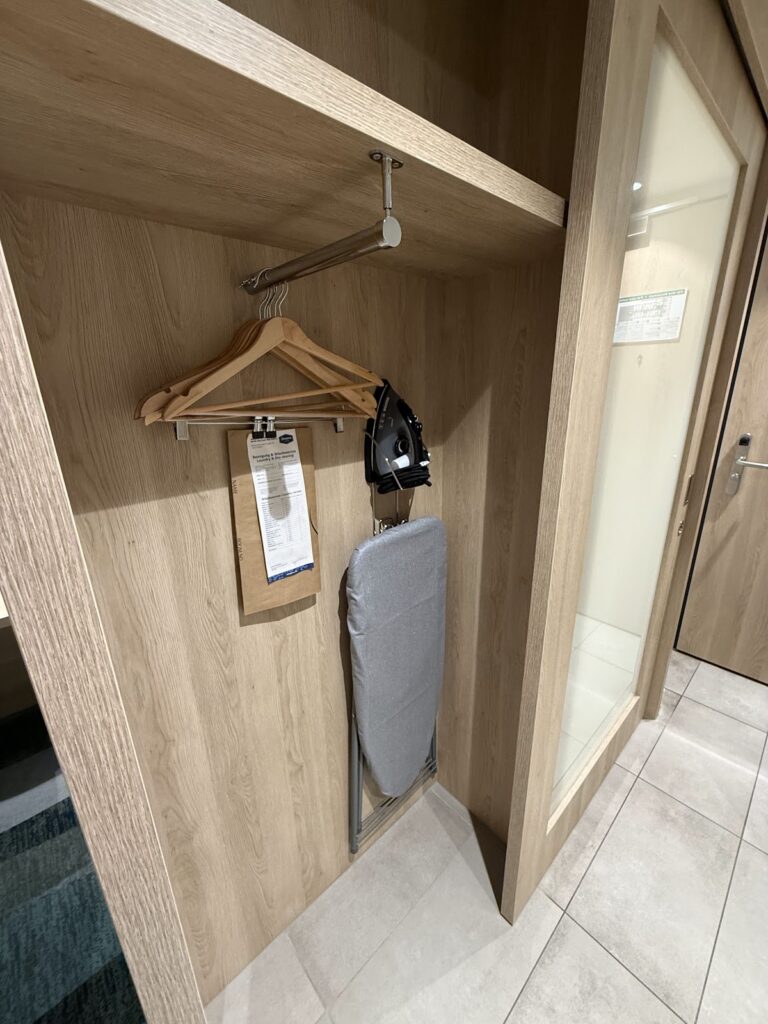 Hotel room wardrobe with wooden interior