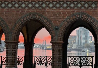 Scenic riverside view through red brick archways at sunrise Berlin