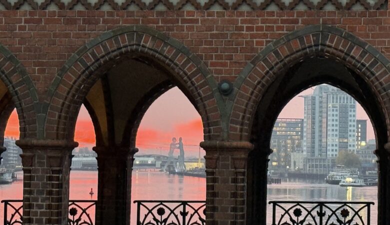 Scenic riverside view through red brick archways at sunrise Berlin