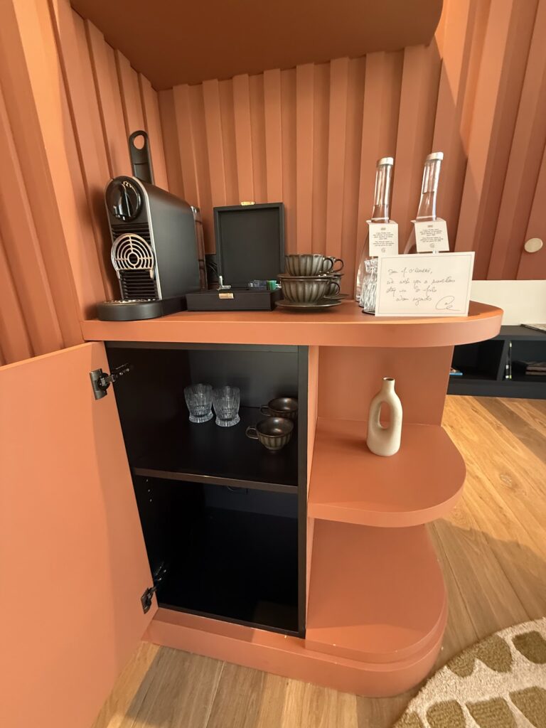 Grand Hotel de Courtoisville room coffee station with Nespresso machine