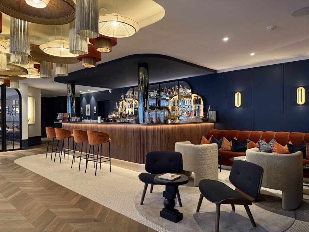 Sophisticated bar and lounge with navy walls and modern fixtures