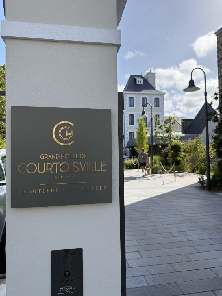 Grand Hotel de Courtoisville St-Malo entrance sign and courtyard