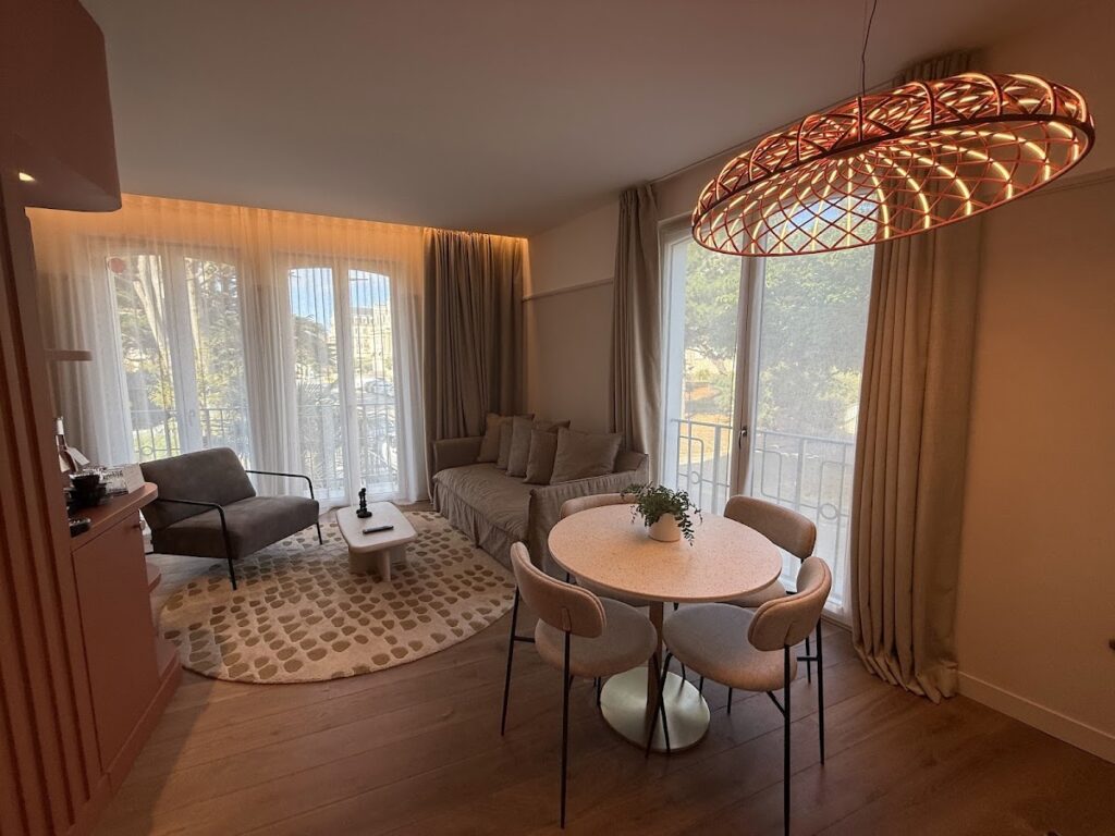 Grand Hotel de Courtoisville suite living area with terrace