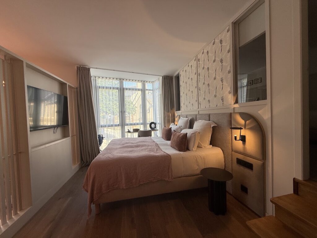 Spacious bedroom with bay window and modern furnishings