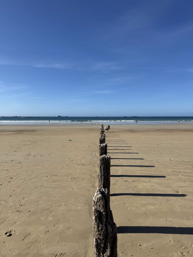 St-Malo beach with wooden groyne and clear sky