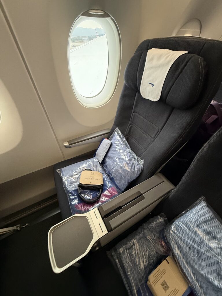 BA premium economy seat with amenity kit and comfortable padding