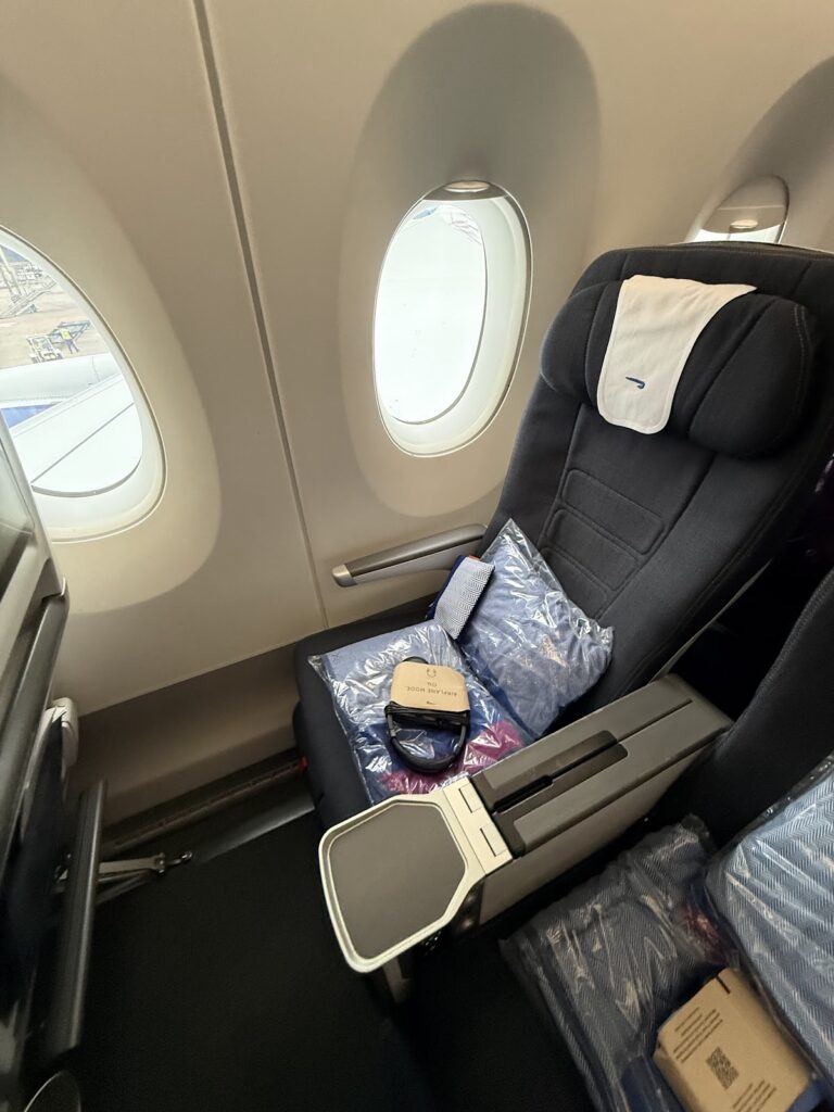 BA premium economy seat with amenity kit and window