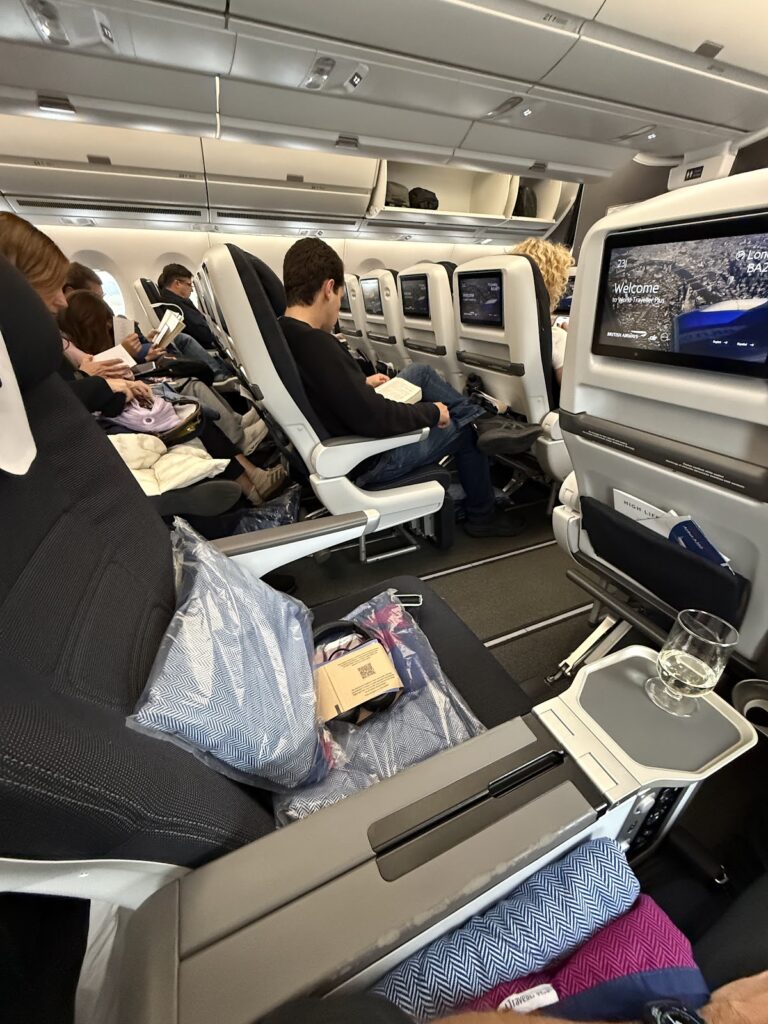 BA premium economy cabin with passengers seated in wider seats