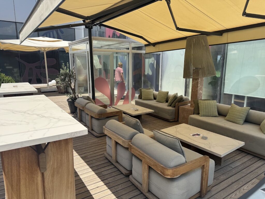 Bodrum airport lounge seating area with yellow umbrellas